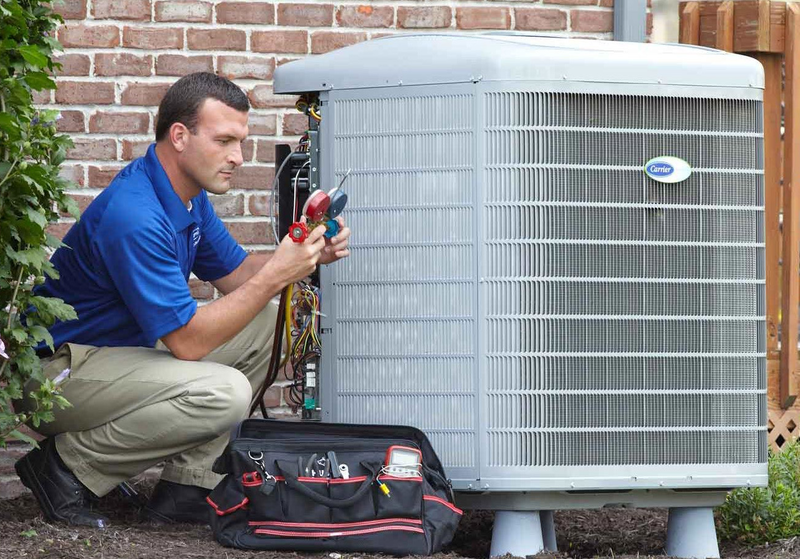 Expert technician performing a detailed air conditioning service check to enhance indoor air quality in Bakersfield home