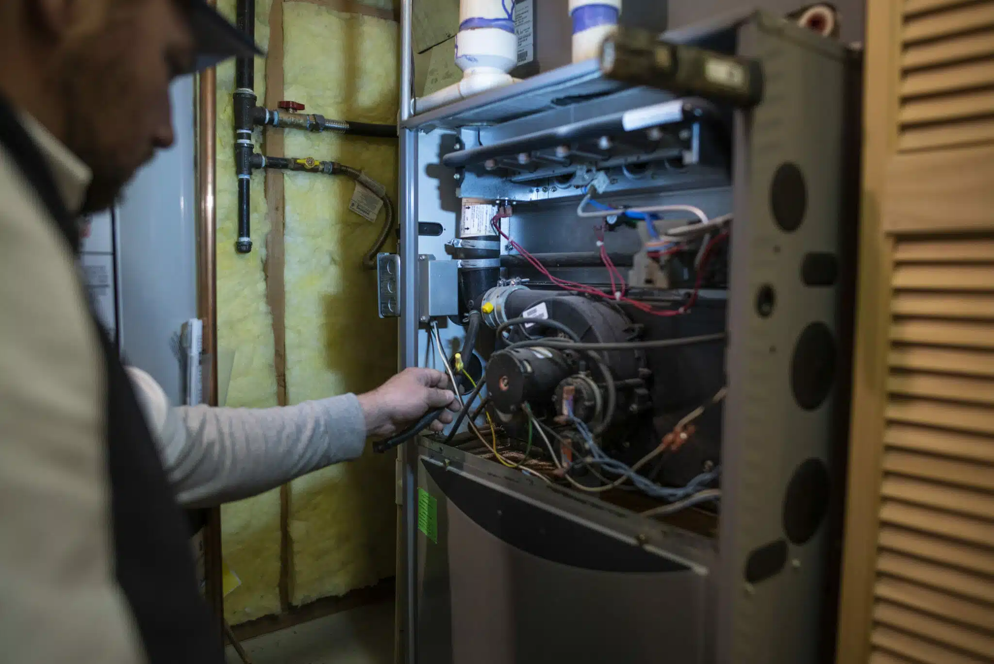 Expert technician conducting a thorough furnace inspection to ensure efficiency and reliability